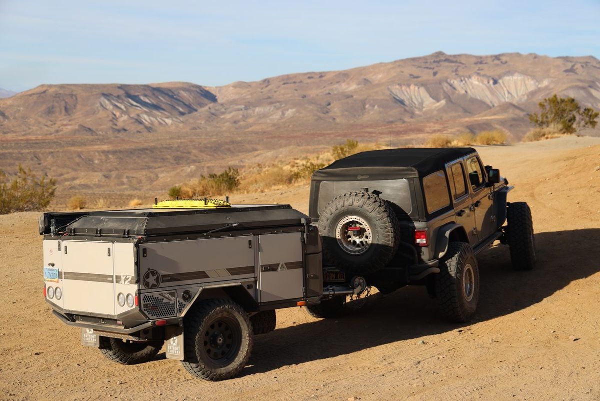 A Jeep and off-road trailer on a dirt road above the El Paso Mountains