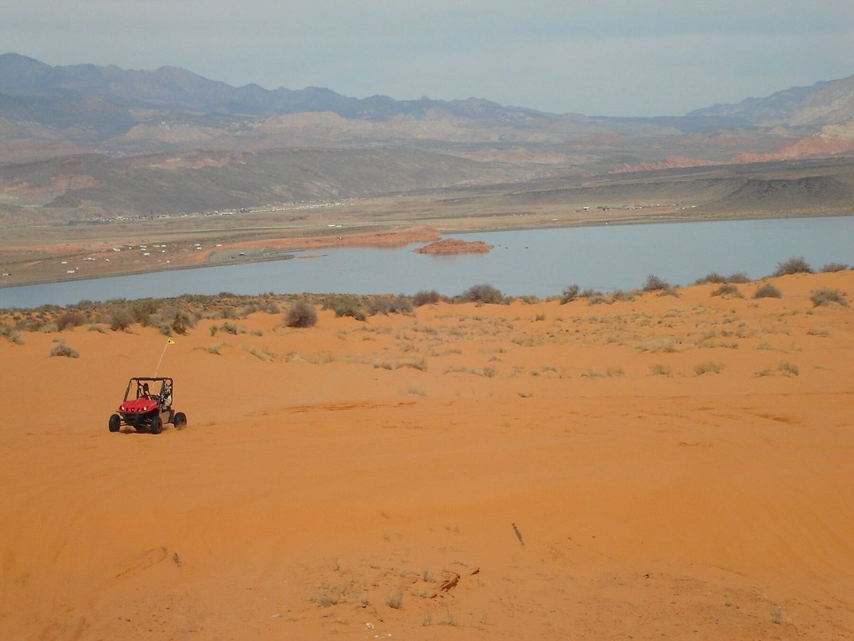 A dune buggy on the orange sand of Sand Mountain above Sand Hollow Reservoir